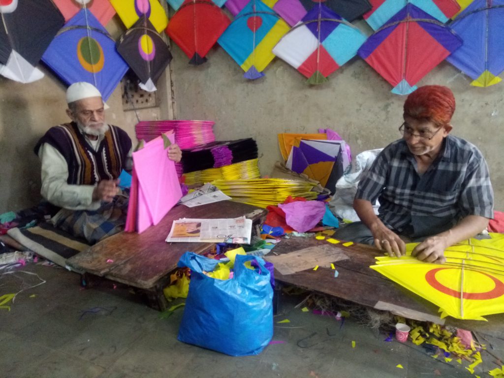 Muslim family making Kites